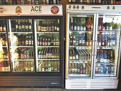 Two refrigerators with different kinds of beer in them.